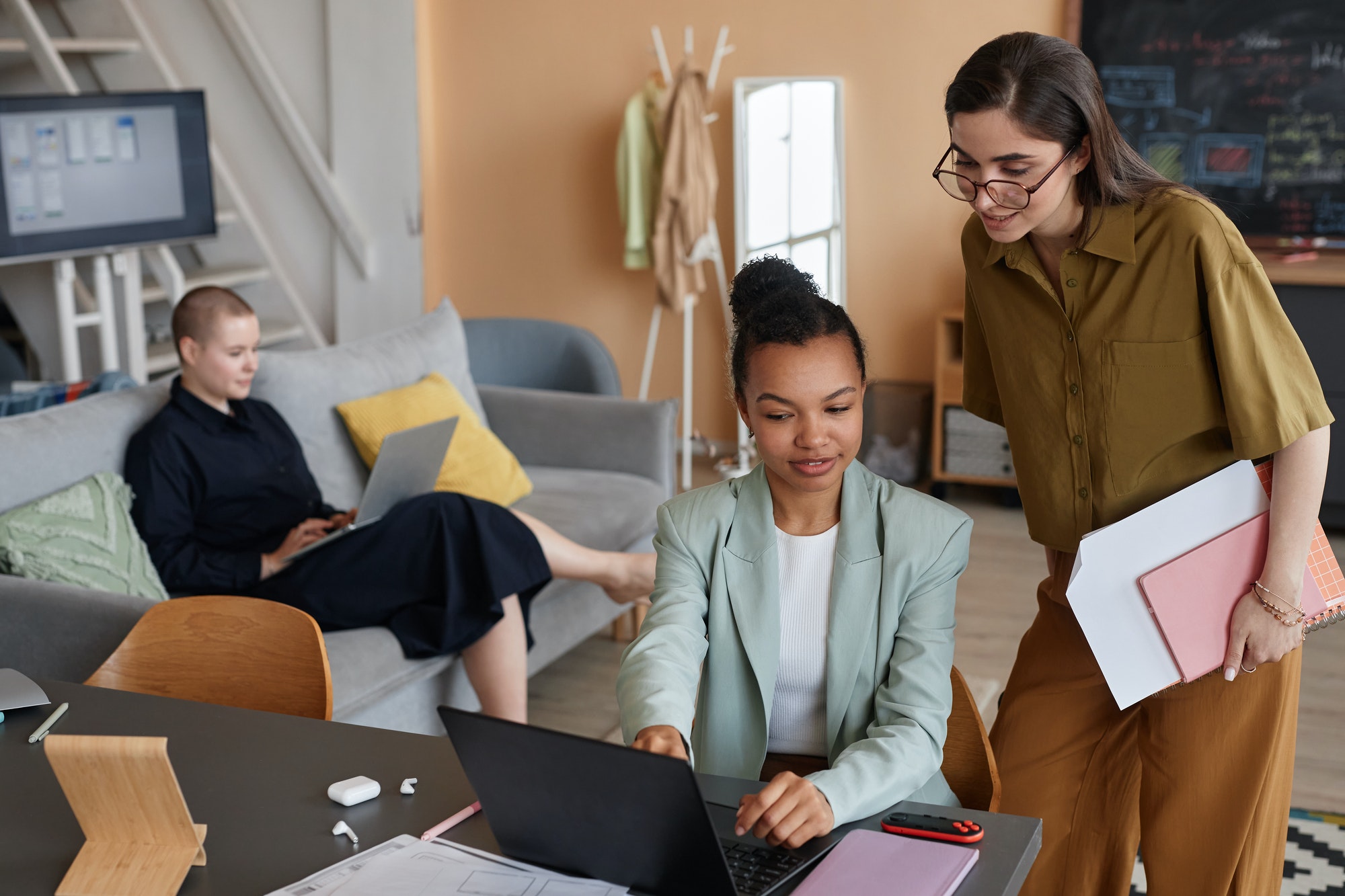 Pastel successful all female business team working together in office